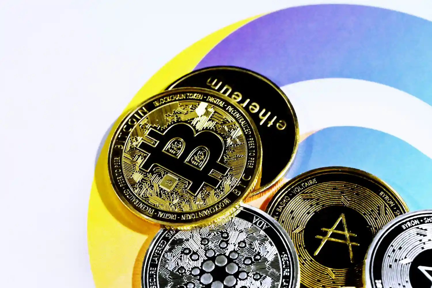 Cryptocurrency coins on a colorful surface